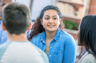 Young Latina woman participating in a support group